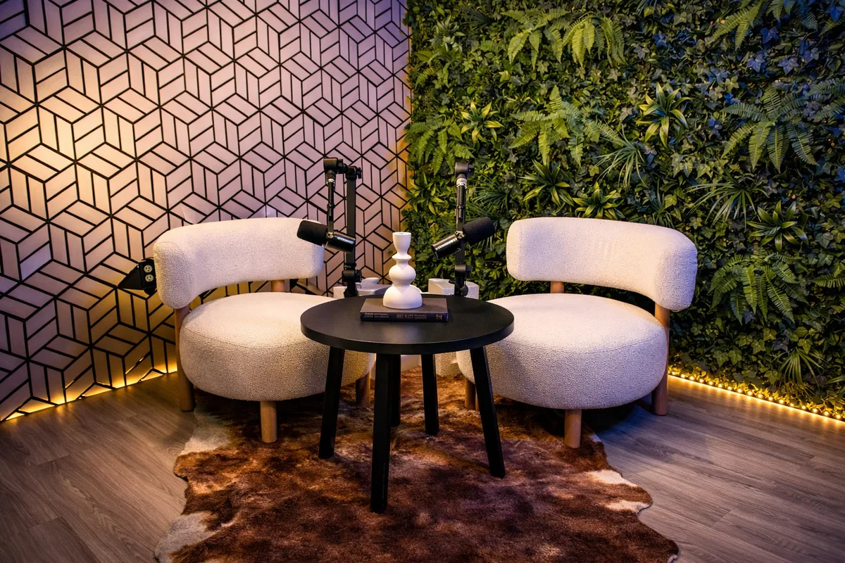 Oasis studio with green living wall, geometric wood panels and lounge seating