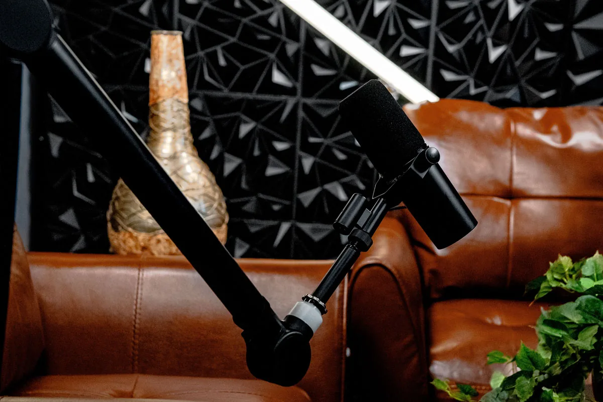 Close-up of Obsidian studio's microphone, leather seating and geometric black wall
